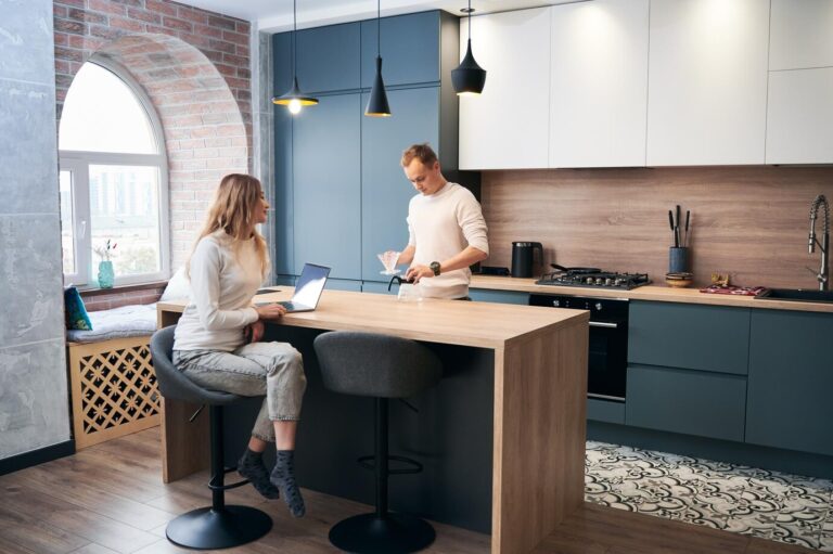 woman-man-working-laptop-home-modern-kitchen_651396-3535